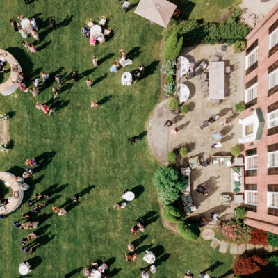 Aerial view of Georgian home and guests during cocktail hour