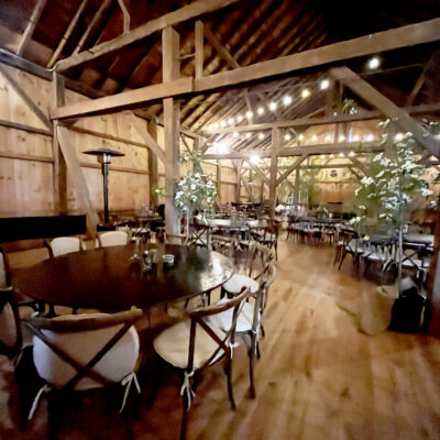 Table and chairs set up for an event in the barn