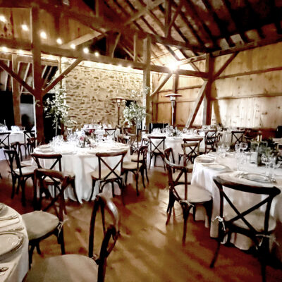 Table and chairs set up for an event in the barn