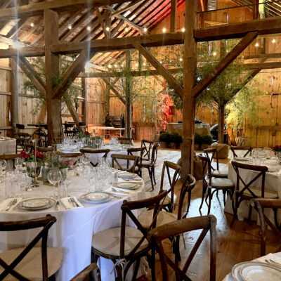 table and chairs set up for an event in the barn