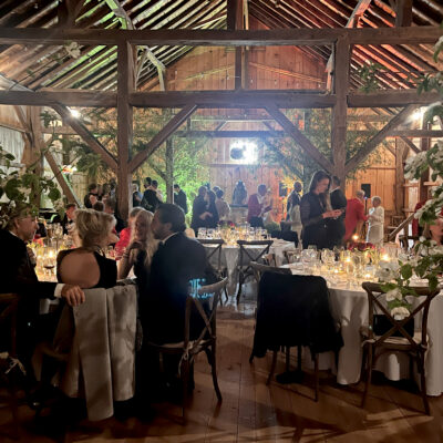 People eating and dancing in barn